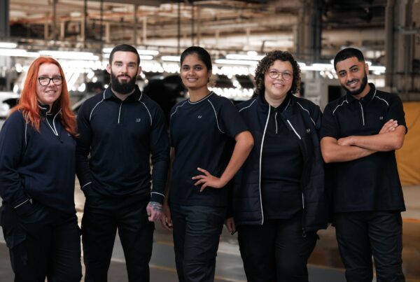 group of automotive manufacturing workers in bespoke uniform